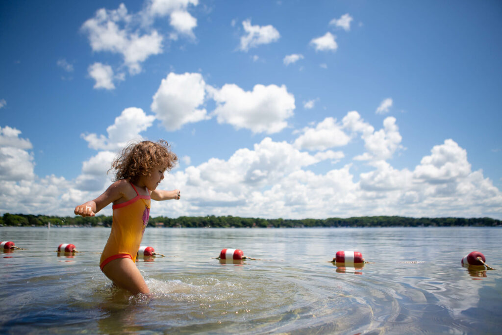 A young girl plays in the water at Lake Monona
